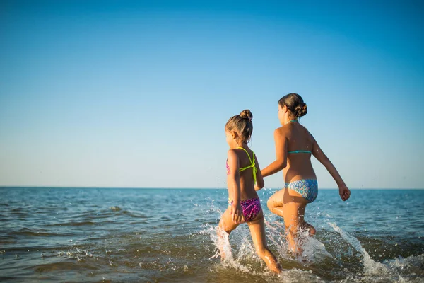 Two happy and positive girls sisters run — 스톡 사진