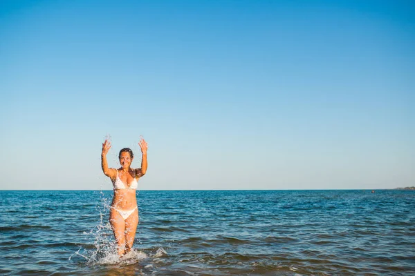 Vista trasera de una bonita joven nadando en el mar — Foto de Stock
