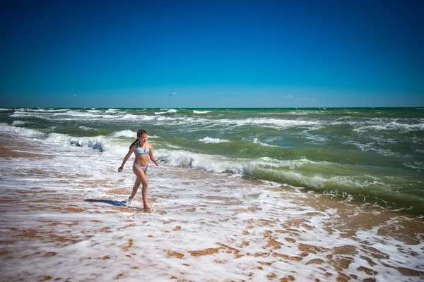 Joyful little active girl jumping on the waves — 스톡 사진