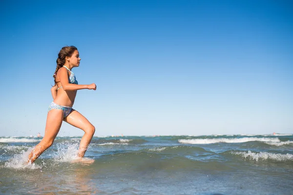 Portrait of a joyful little girl swimming in sea — 스톡 사진