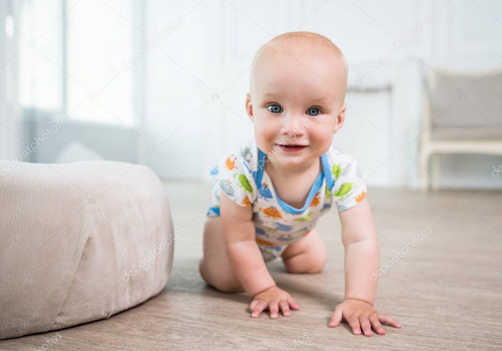 Portrait of a little happy baby crawling