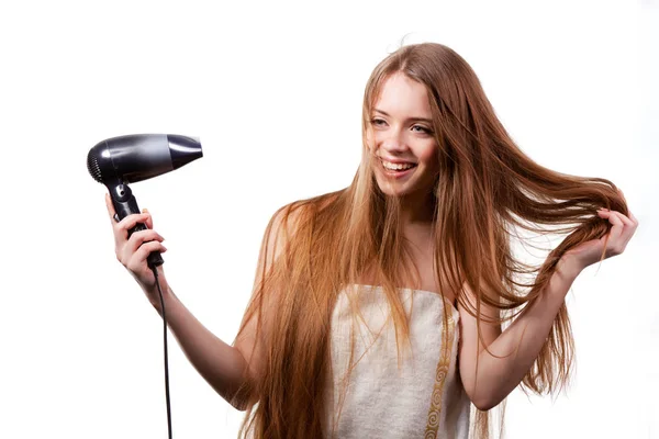 Girl in white towel drying hair with hairdryer — Stock Photo, Image