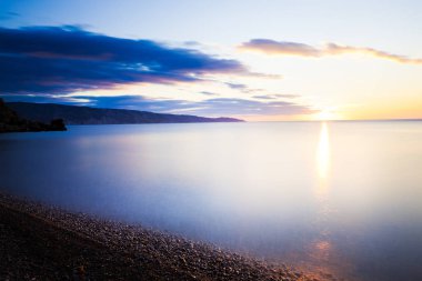 Stones in ocean, shrouded in fog