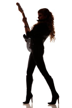 Silhouette of girl with guitar in hands