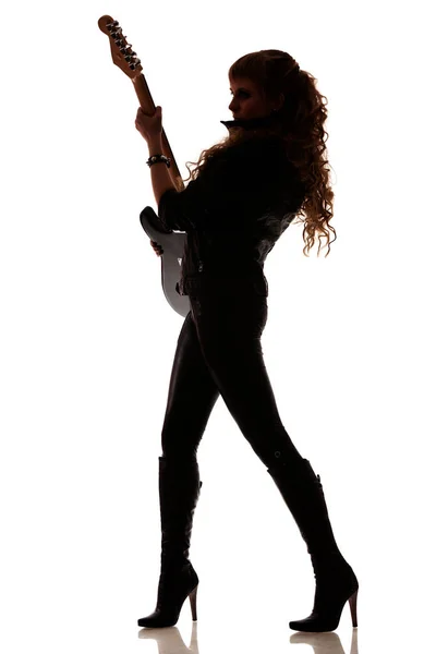 Silhouette of girl with guitar in hands — ストック写真