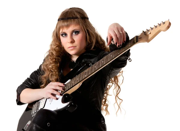 Woman squatting and clutching guitar — Stock Photo, Image