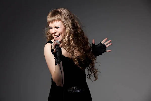 Woman in black dress and gloves singing — Stok fotoğraf