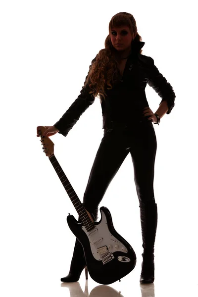 Guitar next to female legs in leather leggings — ストック写真