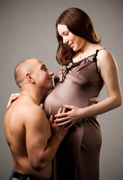 Man hugging belly of pregnant woman — Stock Photo, Image