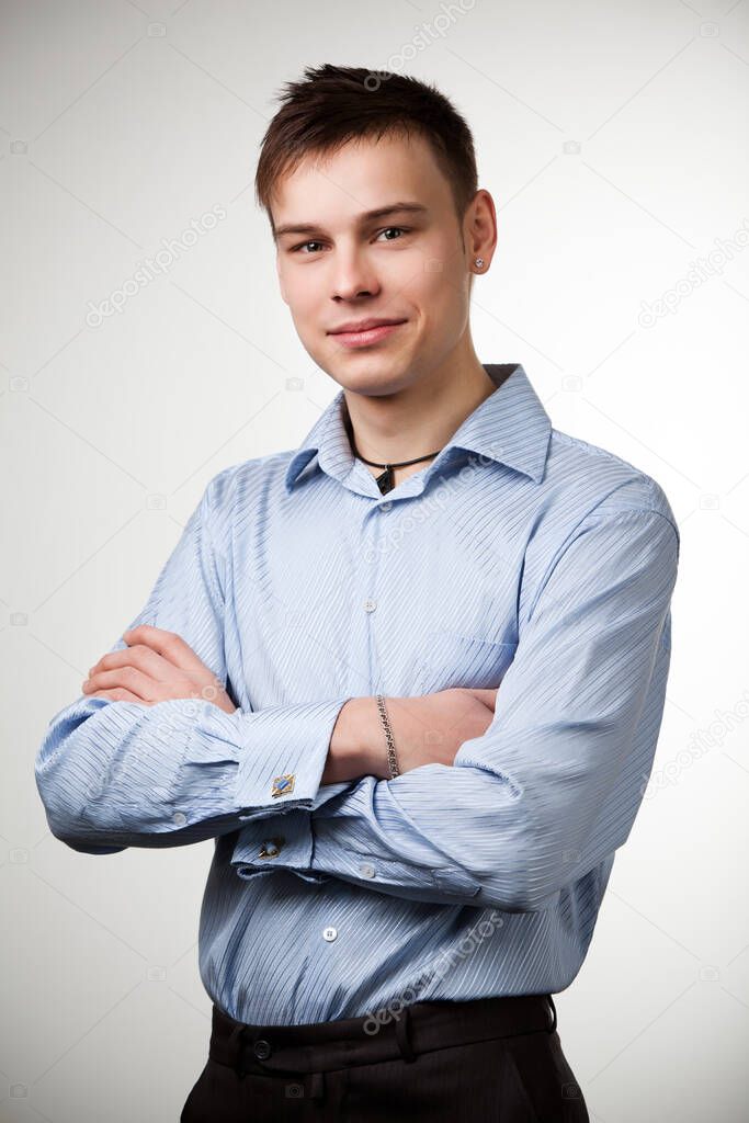Guy in blue shirt with arms crossed on chest