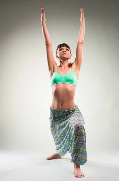 Beautiful young woman doing yoga exercise. — Stock Photo, Image