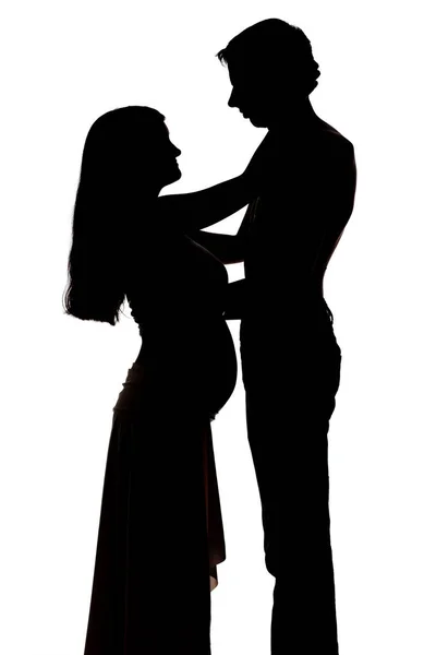 Silhouettes de deux personnes hommes et une femme enceinte — Photo