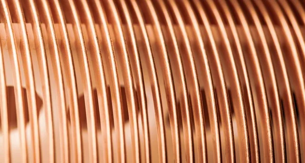 Close-up flat twisted copper wire at a factory for manufacture of components for electronic household appliances and office equipment. Concept manufacturing industrial electronics. Advertising space
