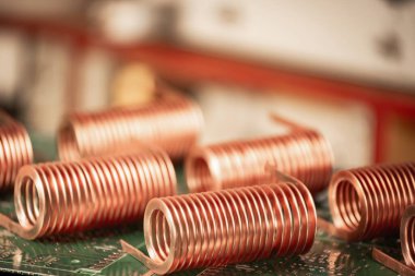 Close-up of high-frequency copper wire on green microcircuit on background of numerous blurry computers. Concept production of super modern high-tech components for transceiver appliances clipart