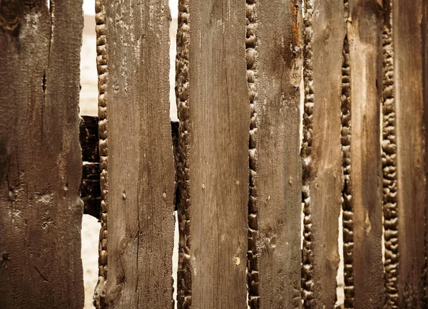 Burnt fence boards after a fire in a private house. The consequences of not careful and thoughtless handling of fire.