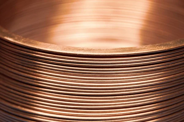 Close-up flat twisted copper wire at a factory for manufacture of components for electronic household appliances and office equipment. Concept manufacturing industrial electronics. Advertising space