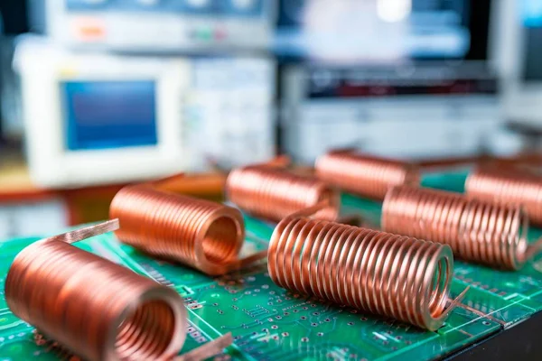 Close-up of high-frequency copper wire on green microcircuit on background of numerous blurry computers. Concept production of super modern high-tech components for transceiver appliances