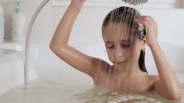 Bir kız kafasını duşun altında yıkıyor, 4K UHD hala video kamera, 2x ağır çekim.