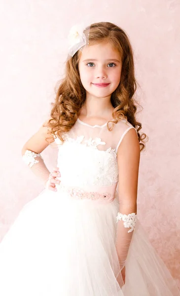 Adorable smiling little girl in white princess dress — Stock Photo, Image