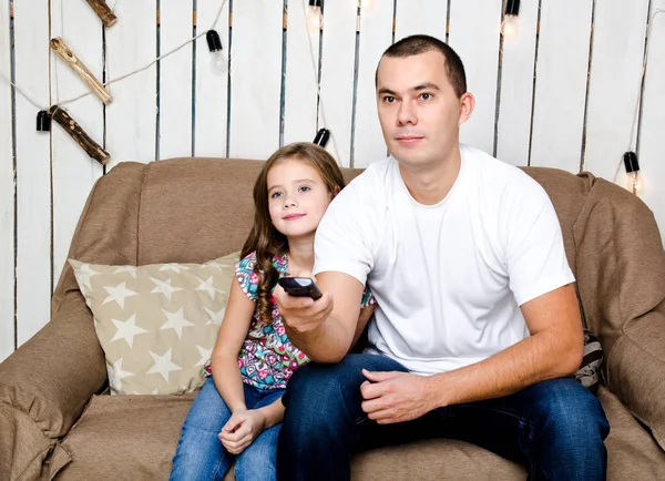 Cute little girl and her father watching tv — Stock Photo, Image