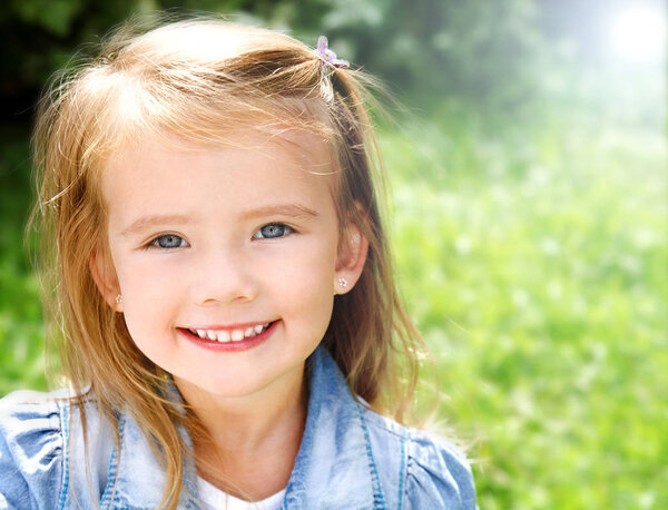 Outdoor portrait of smiling little girl 