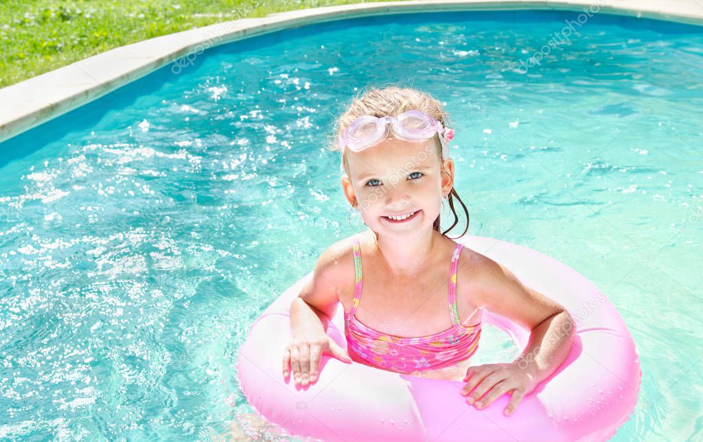 Pretty little girl in swimming pool 