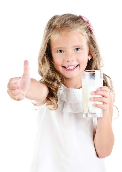 Smiling little girl with glass of milk and finger up — Stock Photo, Image