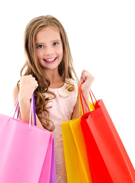 Adorable niña pequeña sosteniendo compras coloridas bolsas de papel —  Fotos de Stock