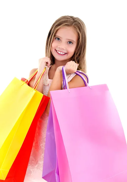 Urocze małe dziecko dziewczynka gospodarstwa, kolorowe papierowe torby na zakupy — Zdjęcie stockowe
