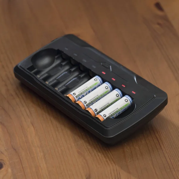 Battery charger and charging the batteries — Stock Photo, Image