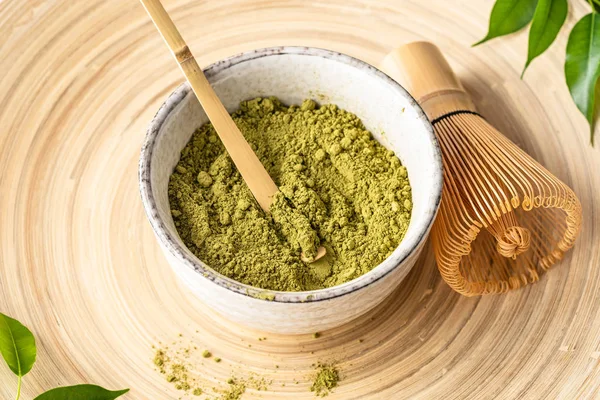 Japanese matcha green tea powder, a healthy natural product, antioxidant. Bamboo spoon and whisk.