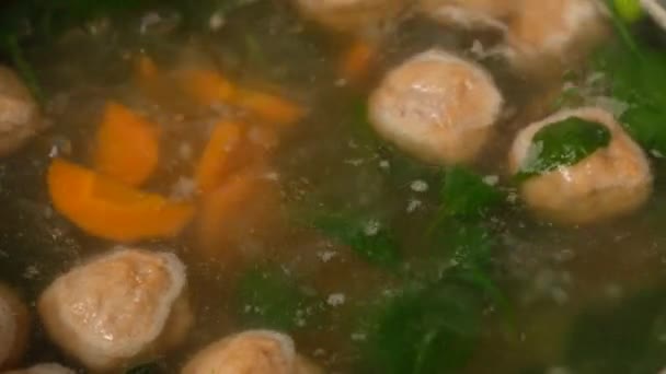 Homemade vegetable soup with meatballs in a pan. Spinach. Close-up. — Stock Footage Homemade vegetable soup with meatballs in a pan. Spinach. Close-up. Stock Footage