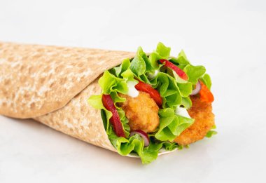 Wrap with fried chicken and vegetables isolated on a white background