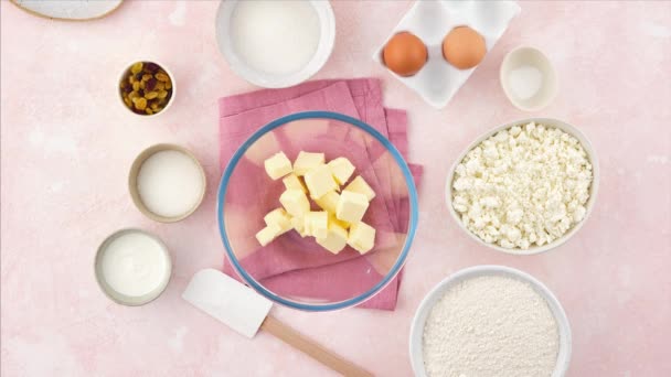 Homemade cookies and cottage cheese. Stop motion food. Sochniki. Cooking Cookies on a delicate pink background. Shortcrust pastry. — Stock Video