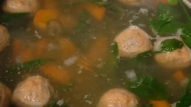 Homemade vegetable soup with meatballs in a pan. Spinach. Close-up. — Stock Footage Homemade vegetable soup with meatballs in a pan. Spinach. Close-up. Royalty Free Stock Video