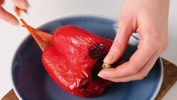 치이 즈 , 모차렐라 , 살라미 , 도마도 , 시금치 , 붉은 고추와 함께 이탈리아 음식 피자 롤 용으로 구운 후추 껍질을 벗기는 여자 손. — 비디오