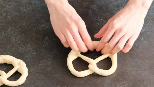 Woman makes pretzels from raw dough. Oktoberfest food menu, soft pretzels and beer . Beer is poured. Misted glass with beer. Britzel. — Stock Video