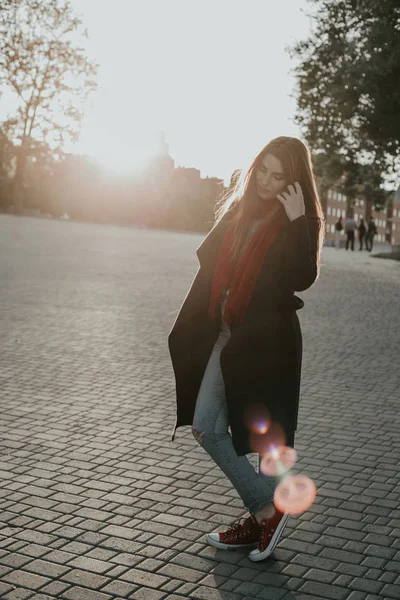 European woman standing on sunset