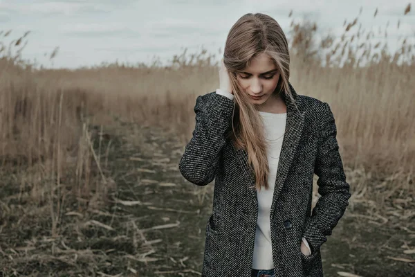 Kız contry yol arka plan üzerinde duran ve aşağı bakıyor