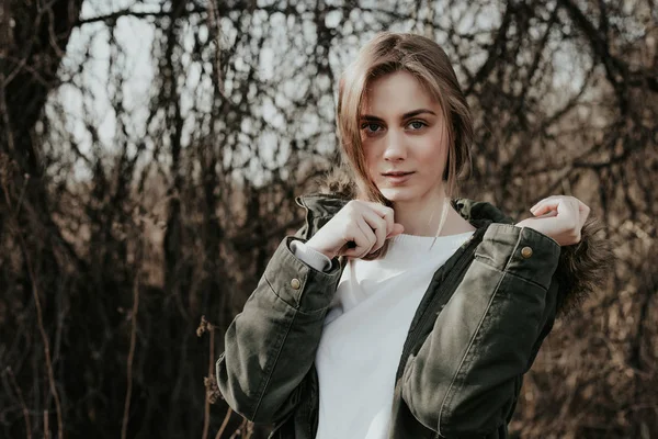 Beautiful young european girl with blonde hair and in winter jacket