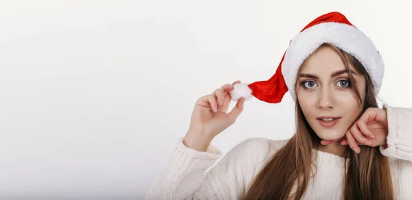 Милая Женщина Смотрит Камеру Поглаживает Свою Рождественскую Шляпу Довольно Молодая — стоковое фото