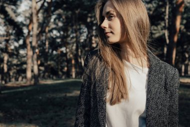 Kendine güvenen kadın yan ağaçlar üzerinde arka plan açık arıyor