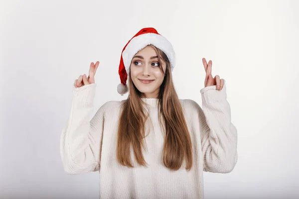 O Noel hediyesini almak umuduyla kız onun parmak çarpı işareti.