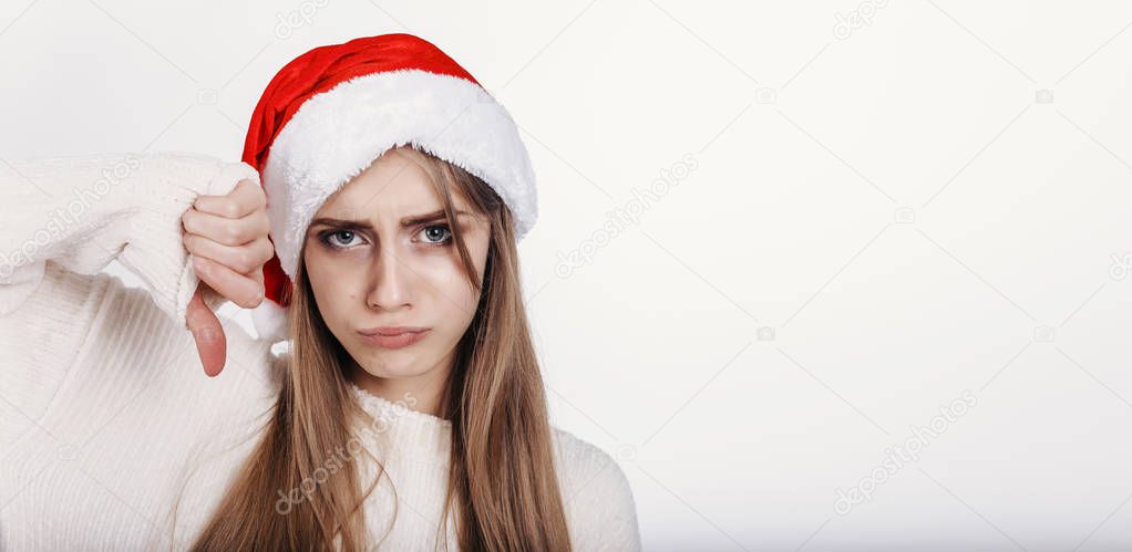 The girl in santa hat with bad mood
