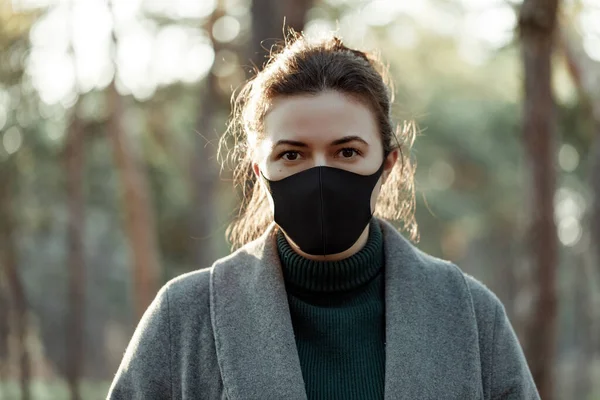 Tıbbi maskeli Avrupalı bir kadın. Virüslere karşı koruyan koruyucu maskeli bir kız.