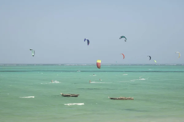 Kitesurfing near fish boats