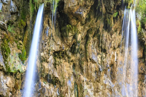 Close up of blue waterfalls in a green forest during daytime in — Stock Photo, Image