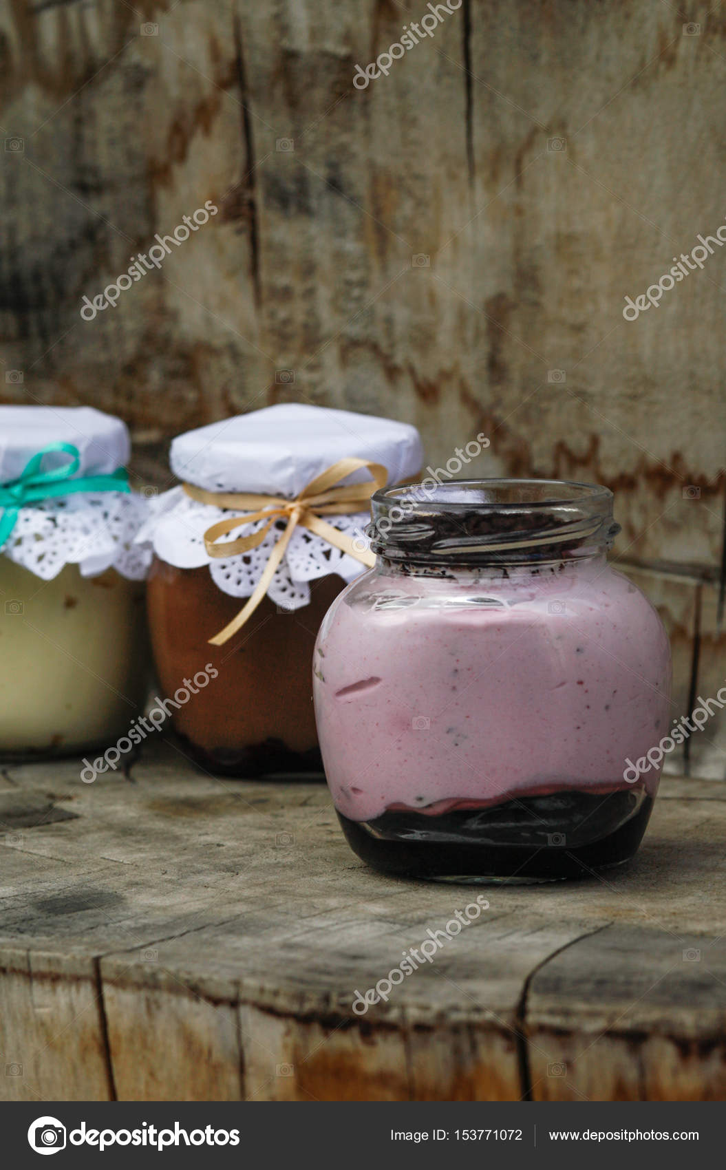 Creamy Dessert In A Small Glass Jars With Ribbon On A Wooden