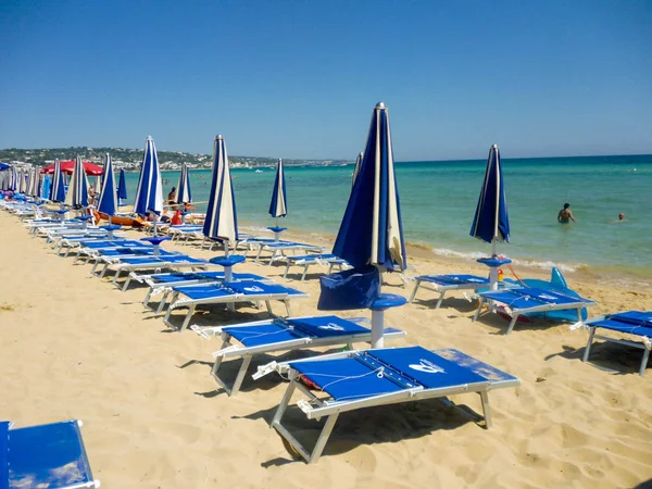 Strand met parasols en ligstoelen — Stockfoto
