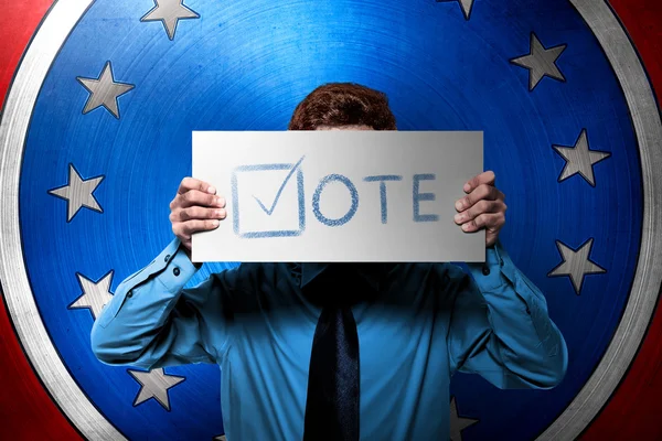 Man holding board with vote sign — Stock Photo, Image